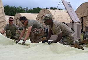 U.S. Air Force Airmen pack tents at Naval Outlying Landing Field Choctaw, Florida, May 4, 2021. The tents were used during Agile Flag 21-2, an experiment that tests a units capability to deploy and succeed in a bare base situation. (U.S. Air Force photo by Senior Airman Sarah Dowe)