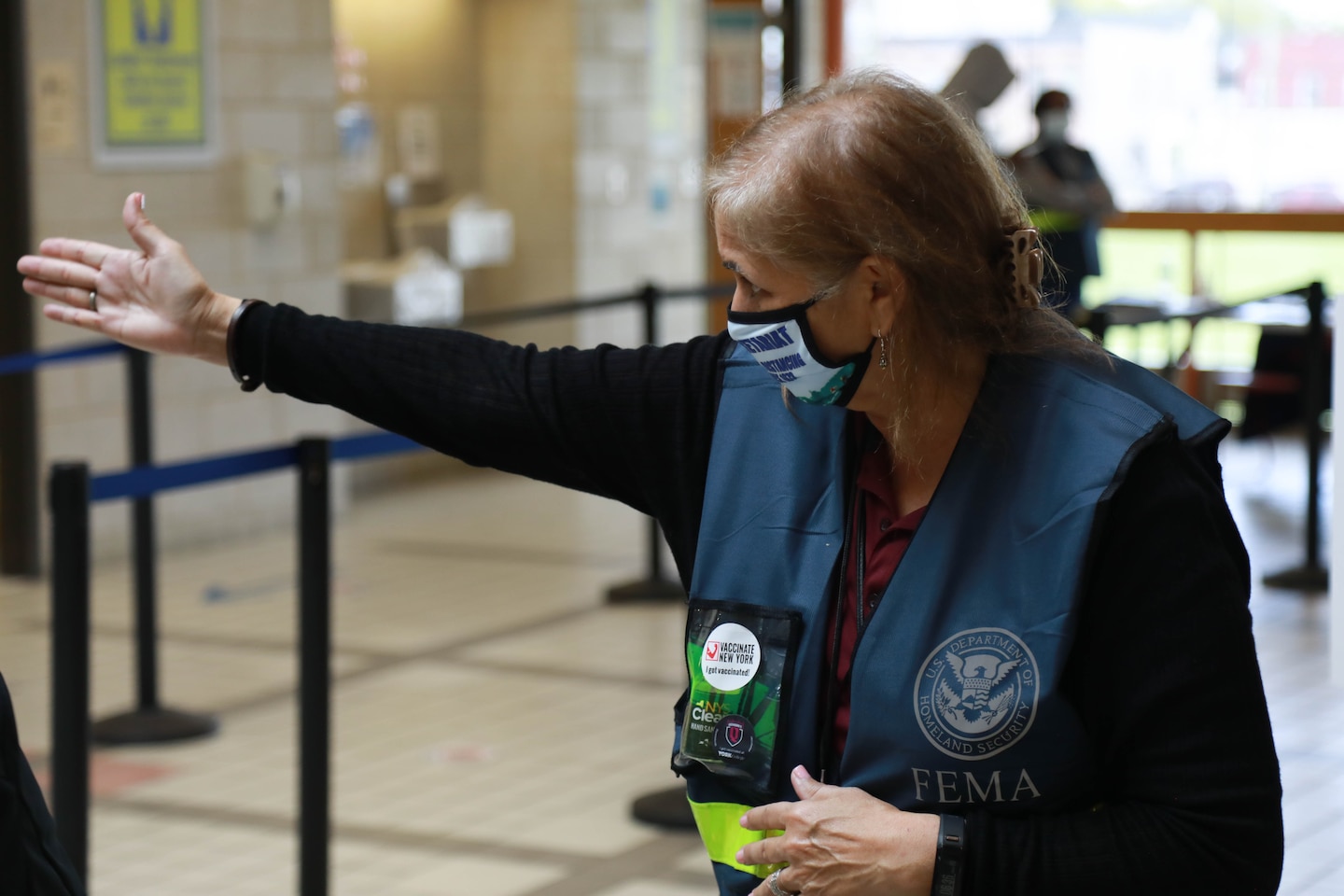 Linda Souza-Barney, a Reemployed Annuitant with the U.S. Army Corps of Engineers, directs patients at the York College Community Vaccination Center in Queens, April 2021. Souza-Barney retired from USACE in 2013.