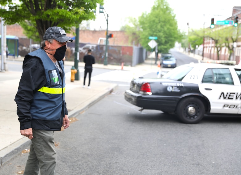 Ed Otto, a Reemployed Annuitant with the U.S. Army Corps of Engineers, heads toward a patient to provide direction and assistance as they arrive to receive a COVID-19 vaccination at the New Jersey Institute of Technology Community Vaccination Center in Newark, N.J., April 2021