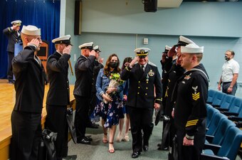 Sailors of the Naval Submarine School's high-risk training department give a final salute to Chief Warrant Officer 3 Mark Cooper during his retirement ceremony onboard Naval Submarine Base New London, Groton, CT, on April 30, 2021. Serving as SUBSCOL’s Pressurized Submarine Escape Trainer diving officer, Cooper retired after over thirty years of service in the U.S. Navy. He was a consummate leader, and a critical figure in maintaining quality of instruction within SUBSCOL’s high-risk training department. (U.S. Navy photo by Charles E. Spirtos/Released)
