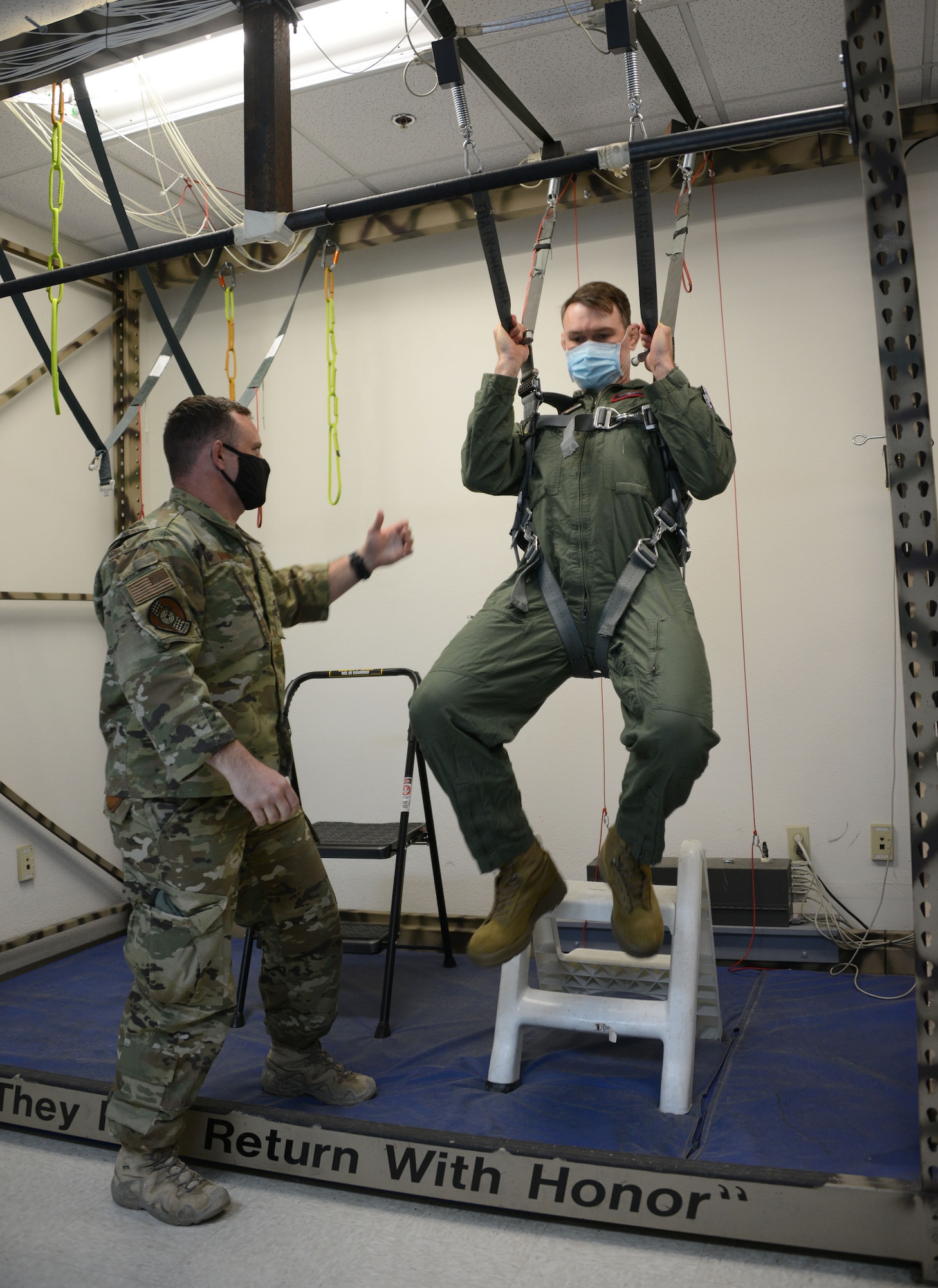 Master Sgt. John Maher, 414th Combat Training Squadron Red Flag section chief, Nellis Air Force Base, Nevada, trains former Ultimate Fighter Championship champion and UFC Hall of Famer Forrest Griffin emergency parachute use prior to his flight with the U.S. Air Force Thunderbirds at Nellis Air Force Base, Nevada, Apr. 2021.