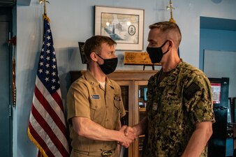 Capt. Steven Antcliff, commanding officer of the Naval Submarine School, presents Lt. Alexander Graham, SUBSCOL Legal Officer, with a Navy and Marine Corps Commendation Medal as an end of tour award during a ceremony at Naval Submarine Base New London, Groton, CT, on May 5, 2020. During his two years as legal officer, Graham flawlessly executed over 600 legal and administrative cases while mentoring and training his staff of mostly out of rate Sailors. Graham's expertise and dedication were critical in maintaining good order and discipline at Naval Submarine School. (U.S. Navy photo by Charles E. Spirtos/Released)