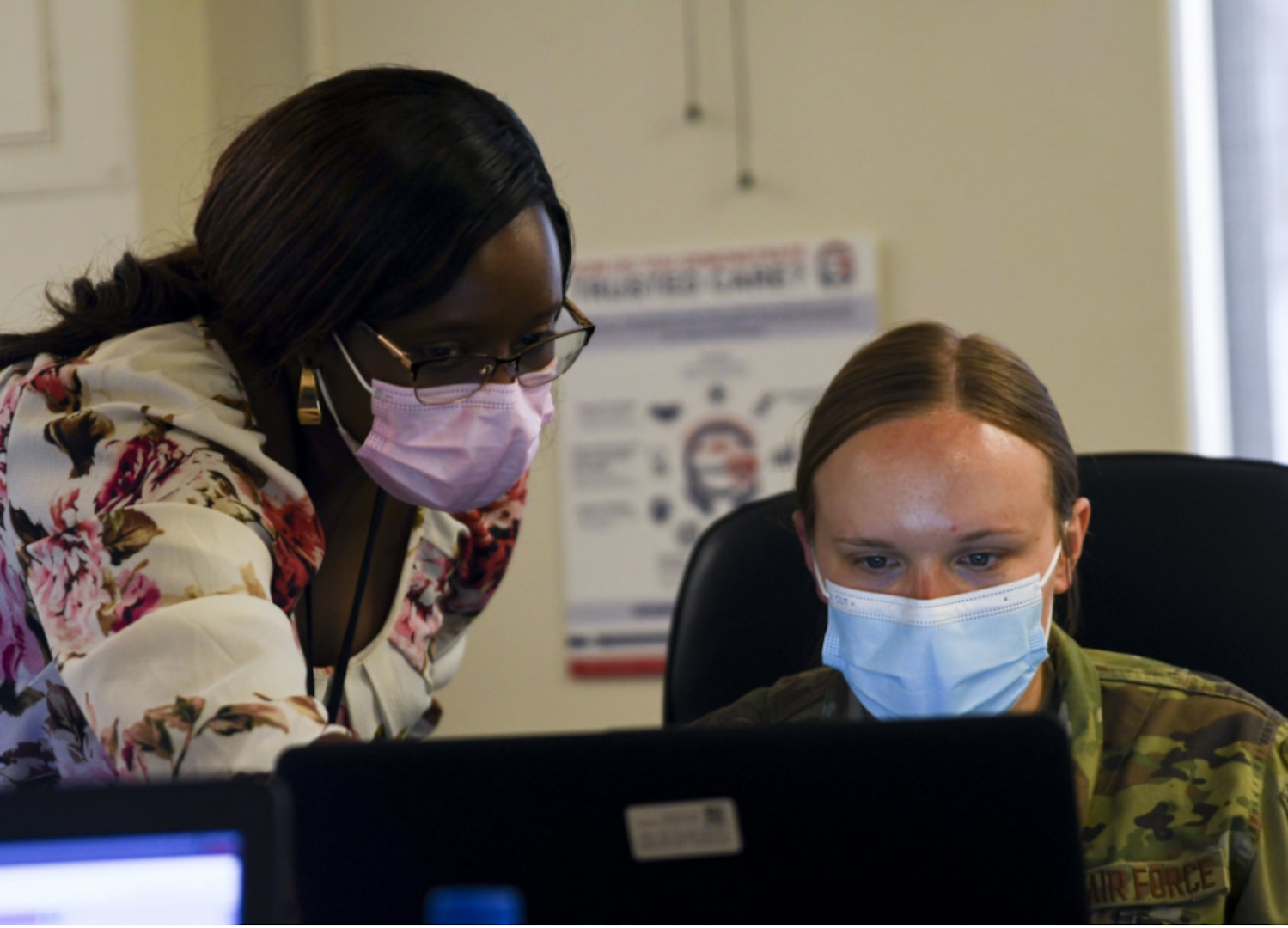 Marion Kimani, Military Health System GENESIS trainer, gives instruction to Airman 1st Class Jenna Slaughter, 355th Mental Health technician, at Davis-Monthan Air Force Base, Arizona, April 7, 2021.