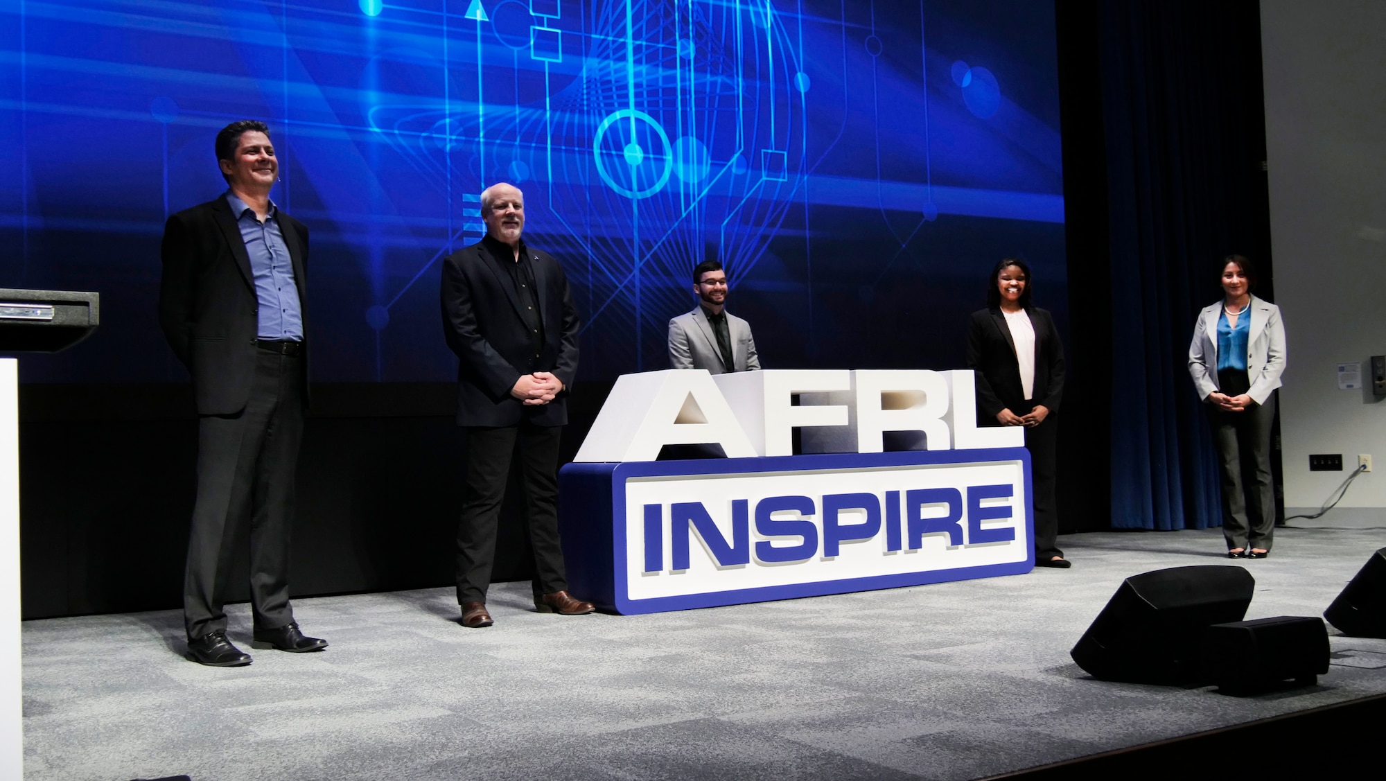 Dr. James Christensen, Dr. Joel Mozer, Kenneth McNulty, Dr. Nia Peters and Sara Telano on stage during AFRL Inspire 2021. (U.S. Air Force photo/Keith Lewis)