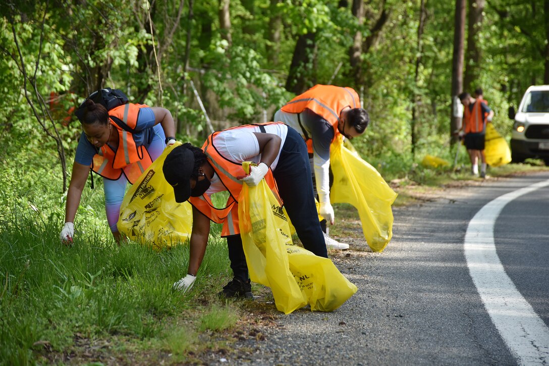 Airmen gather trash during Earth Week, April 28, 2021, near Joint Base Andrews, Md. Properly disposing of trash helps keep natural spaces green, prevents wildlife from being exposed to potential hazards, and allows Airmen to give back to the local community. (U.S. Air Force photo by Senior Airman Daniel Brosam)