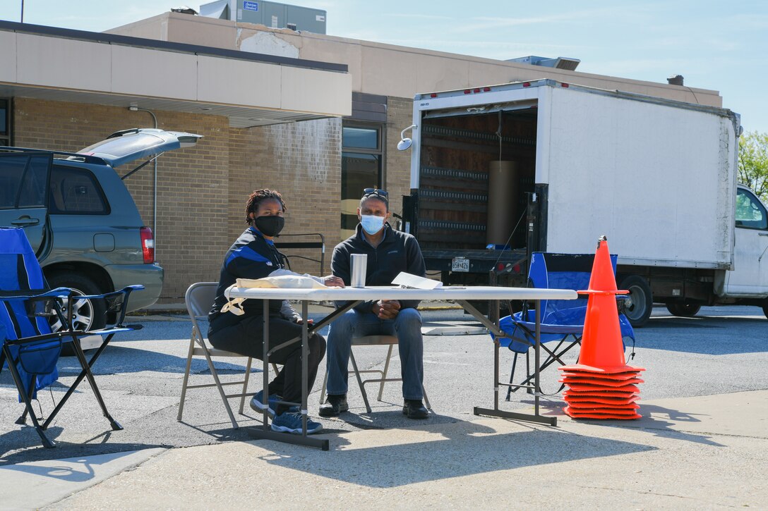 Kimberly White and Timothy Hammond, 316th Civil Engineer Squadron hazardous material program contractors, pose for a photo during a hazardous waste turn-in event at Joint Base Andrews, Md., April 27, 2021. The free event allowed residents of JBA to bring hazardous waste such as electronics, paint, oil and cleaning products and properly dispose of them. (U.S. Air Force photo by Airman 1st Class Bridgitte Taylor)