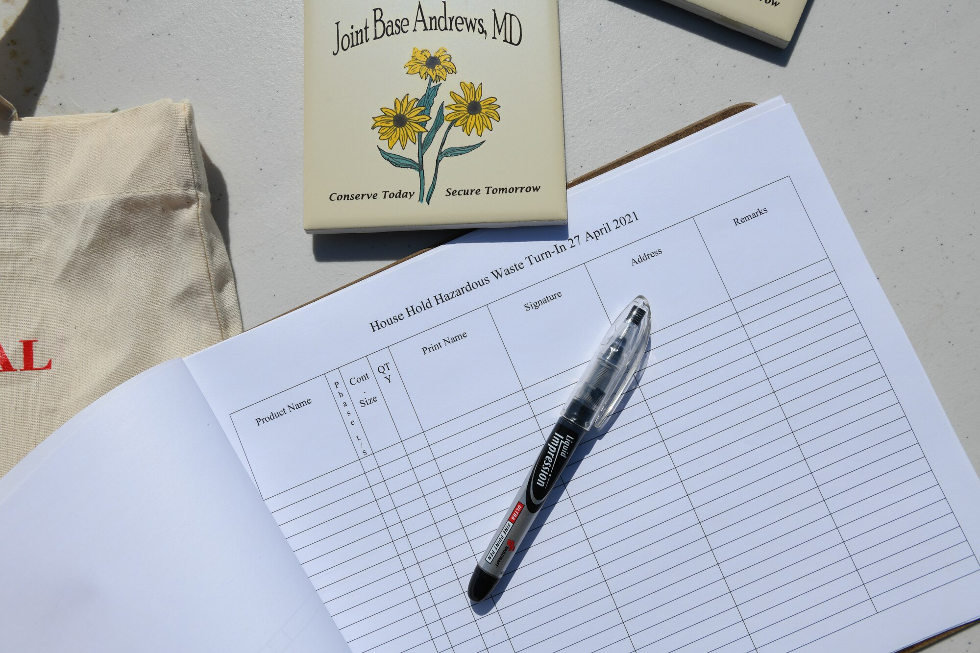 A signup sheet for the hazardous waste turn-in event, hosted by the 316th Civil Engineer Squadron, sits on a table ready for use at Joint Base Andrews, Md., April 27, 2021. The turn-in was one of a series of base-wise events intended to safely collect hazardous waste from JBA residents, educate them on the importance of proper waste disposal, and to celebrate Earth Week. (U.S. Air Force photo by Airman 1st Class Bridgitte Taylor)