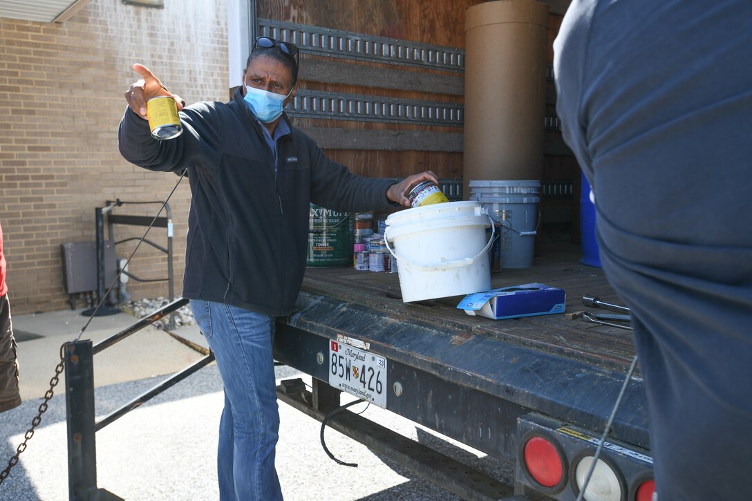 Timothy Hammond, 316th Civil Engineer Squadron hazardous material program contractor, talks to a customer about the recent donation of old paints during a hazardous waste turn-in event at Joint Base Andrews, Md., April 27, 2021. Although this was a one-time free event for the residents of JBA, locals are encouraged to continually dispose of their hazardous waste at the Brown Station Road Sanitary Landfill in Upper Marlboro, Md. The landfill accepts hazardous waste items such as electronics, paints, oils, cleaning products and chemicals, all for free. (U.S. Air Force photo by Airman 1st Class Bridgitte Taylor)