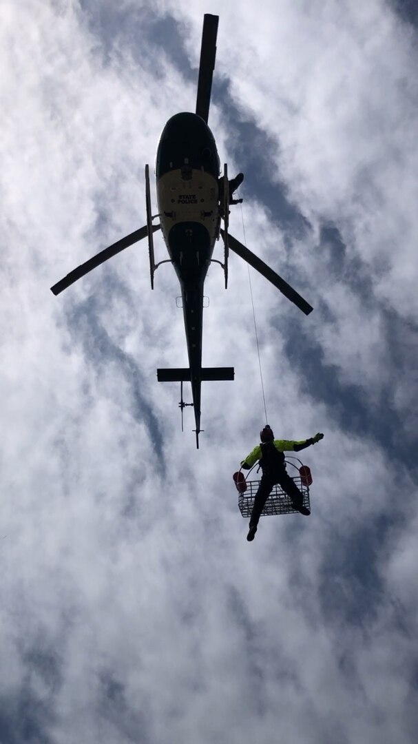 Helicopter hoists a person