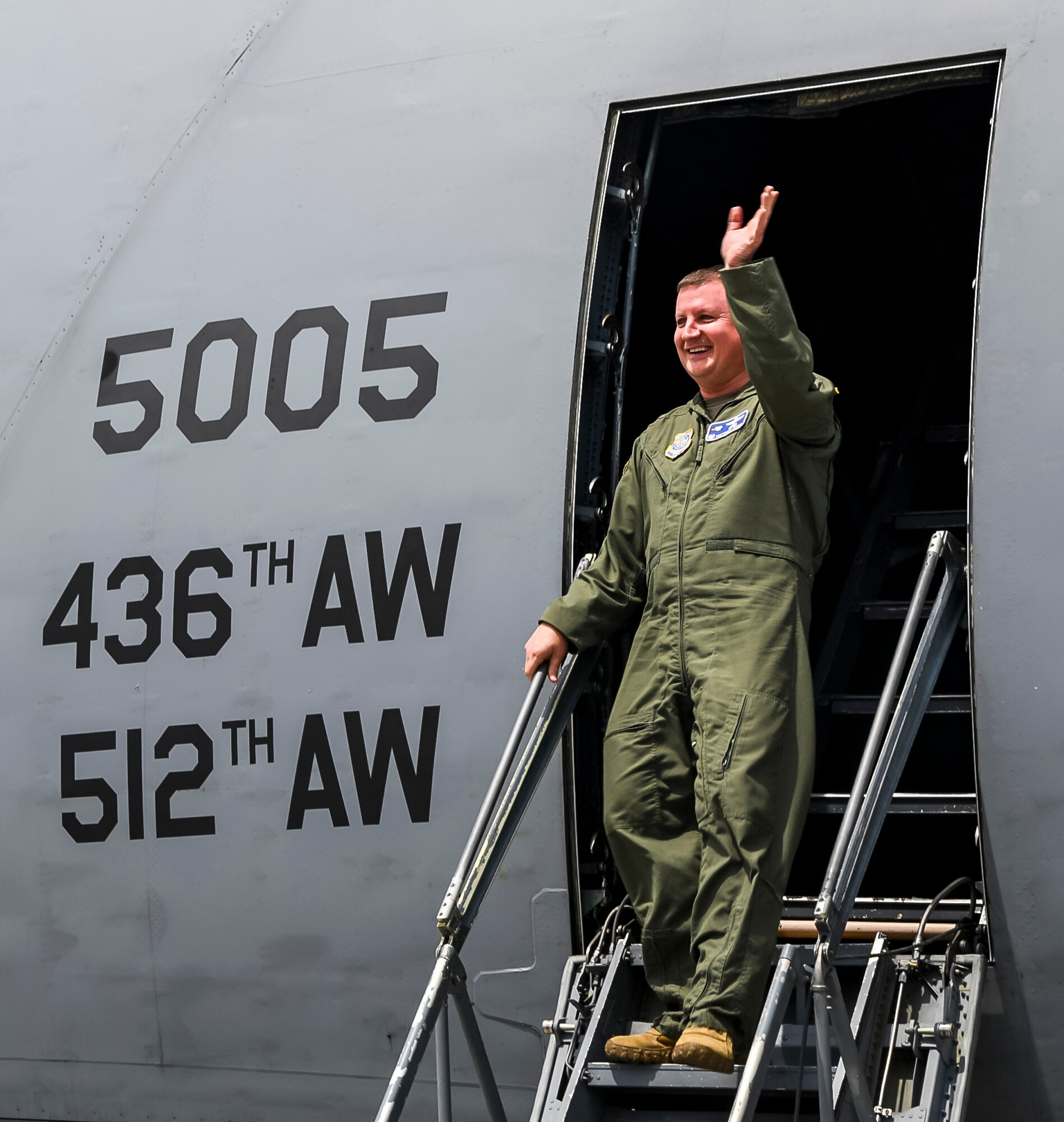 Col. Matthew Jones, 436th Airlift Wing commander, waves to family and colleagues following his fini flight in a C-5M Super Galaxy at Dover Air Force Base, Delaware, May 4, 2021. A “fini flight” is an Air Force tradition where an Airman and their family celebrate their final flight. (U.S. Air Force photo by Airman 1st Class Stephani Barge)