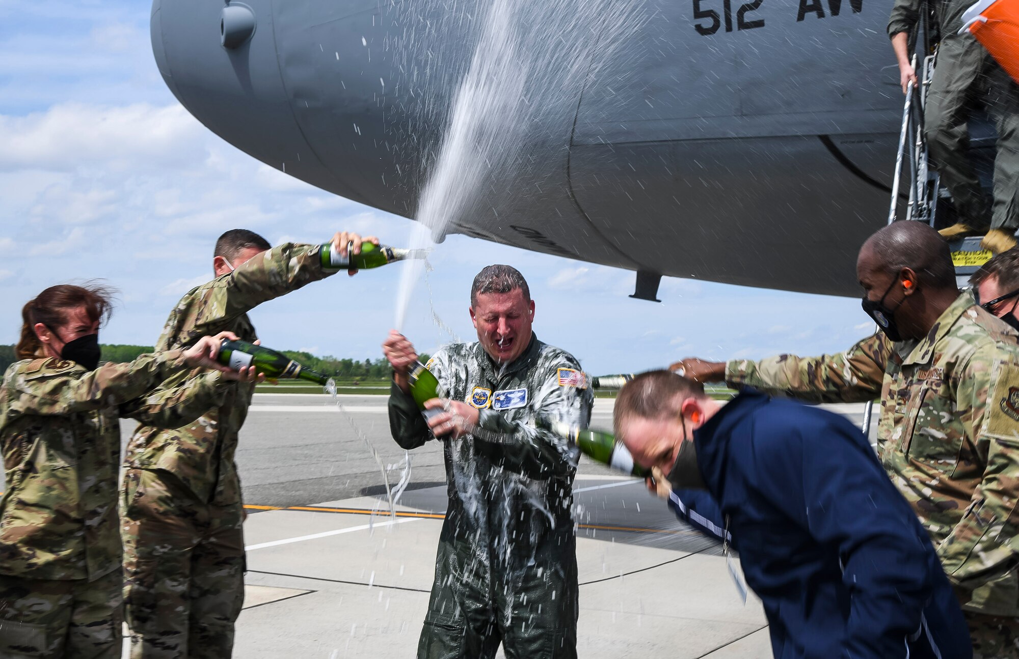 Col. Matthew Jones, 436th Airlift Wing commander, celebrates with colleagues following his fini flight at Dover Air Force Base, Delaware, May 4, 2021. A “fini flight” is an Air Force tradition where an Airman and their family celebrate their final flight. (U.S. Air Force photo by Airman 1st Class Stephani Barge)