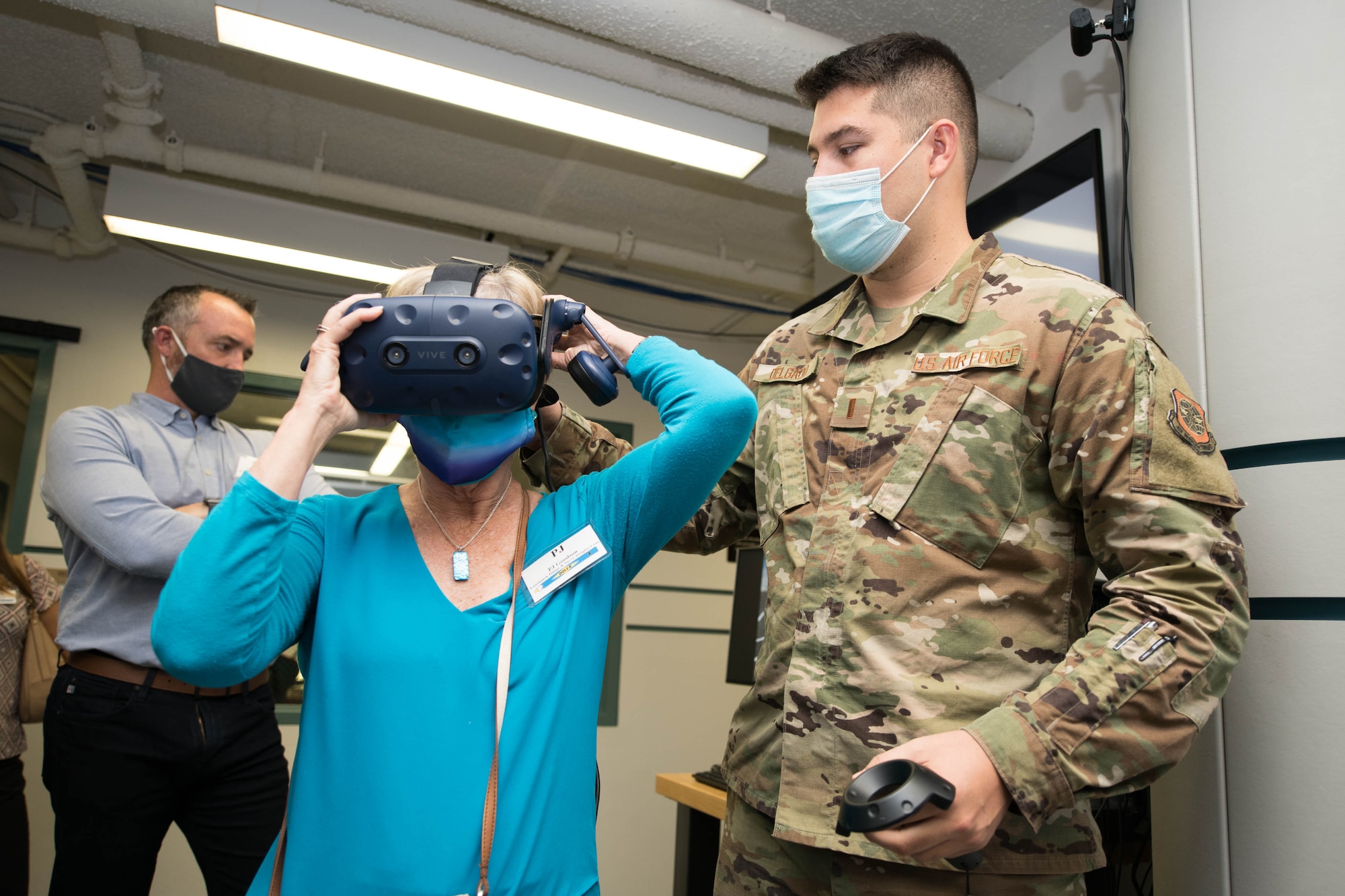 First Lt. Cole Delgado, 436th Operations Support Squadron lab marketing director, demonstrates a virtual reality trainer prototype for the C-5M Super Galaxy to Pamela Gibson, a Travis Air Force Base, California honorary commander, at the Bedrock Innovation Lab at Dover AFB, Delaware, May 4, 2021. The group of 15 honorary commanders toured various facilities at Dover AFB to gain a greater understanding of the base’s mission. (U.S. Air Force photo by Mauricio Campino)