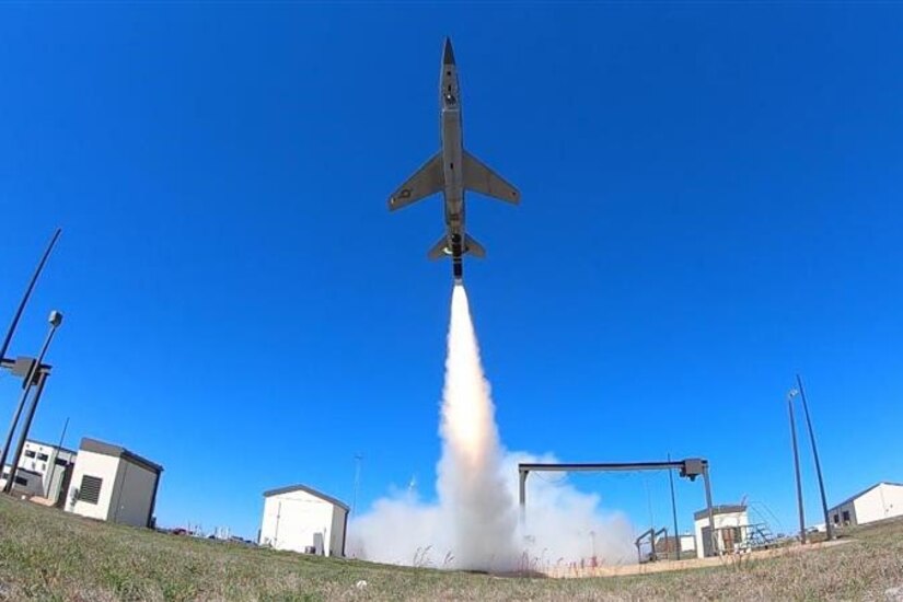 A military aircraft launches into the air.