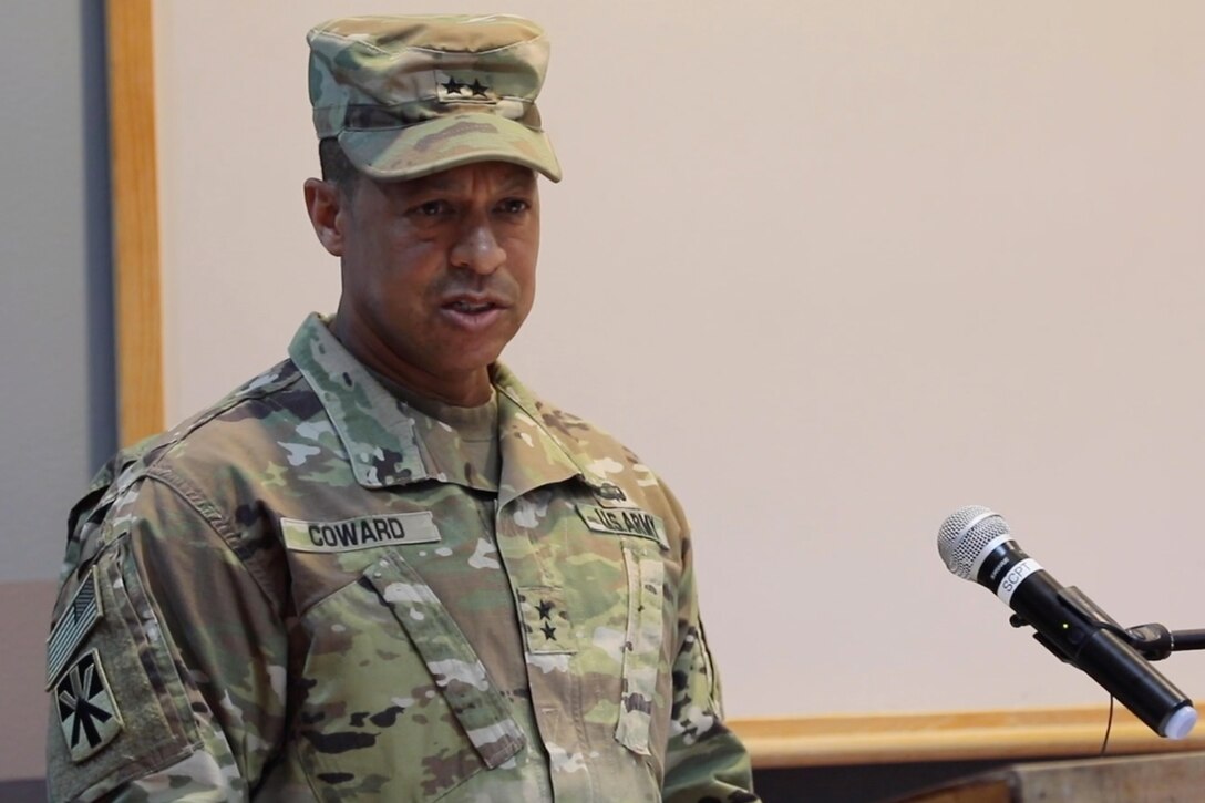 An Army general speaks in front of a microphone.