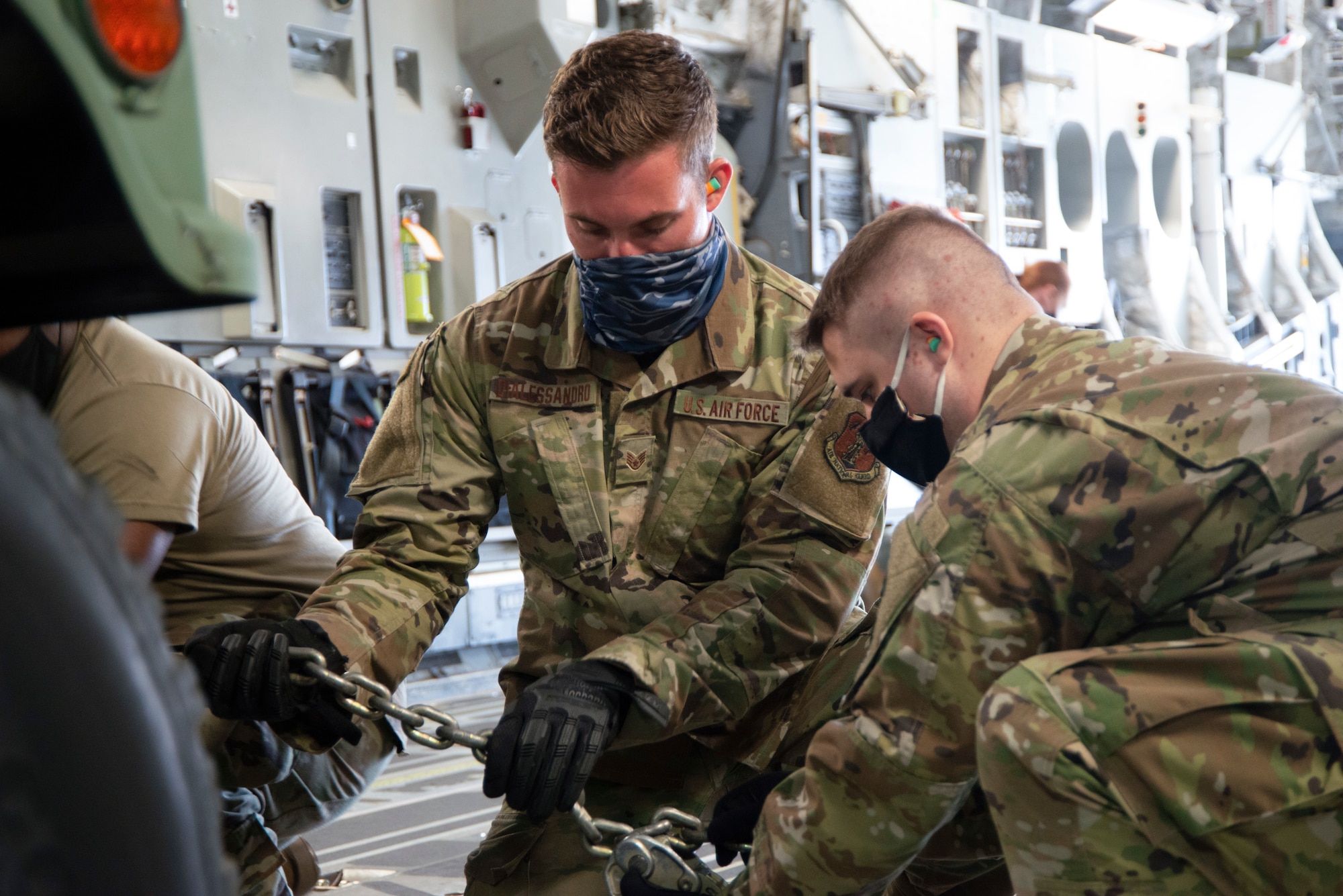 Staff Sgt. Mario Dialessandro and Senior Airman Brad Butella, air transportation augmentees from the 166th Maintenance Group, secure cargo on a C-17 Globemaster III. The 167th and 166th Airlift Wings partnered together to conduct a joint cargo loading exercise as part of the 166th's home station operational readiness exercise May 3 at New Castle Air National Guard Base, Delaware.