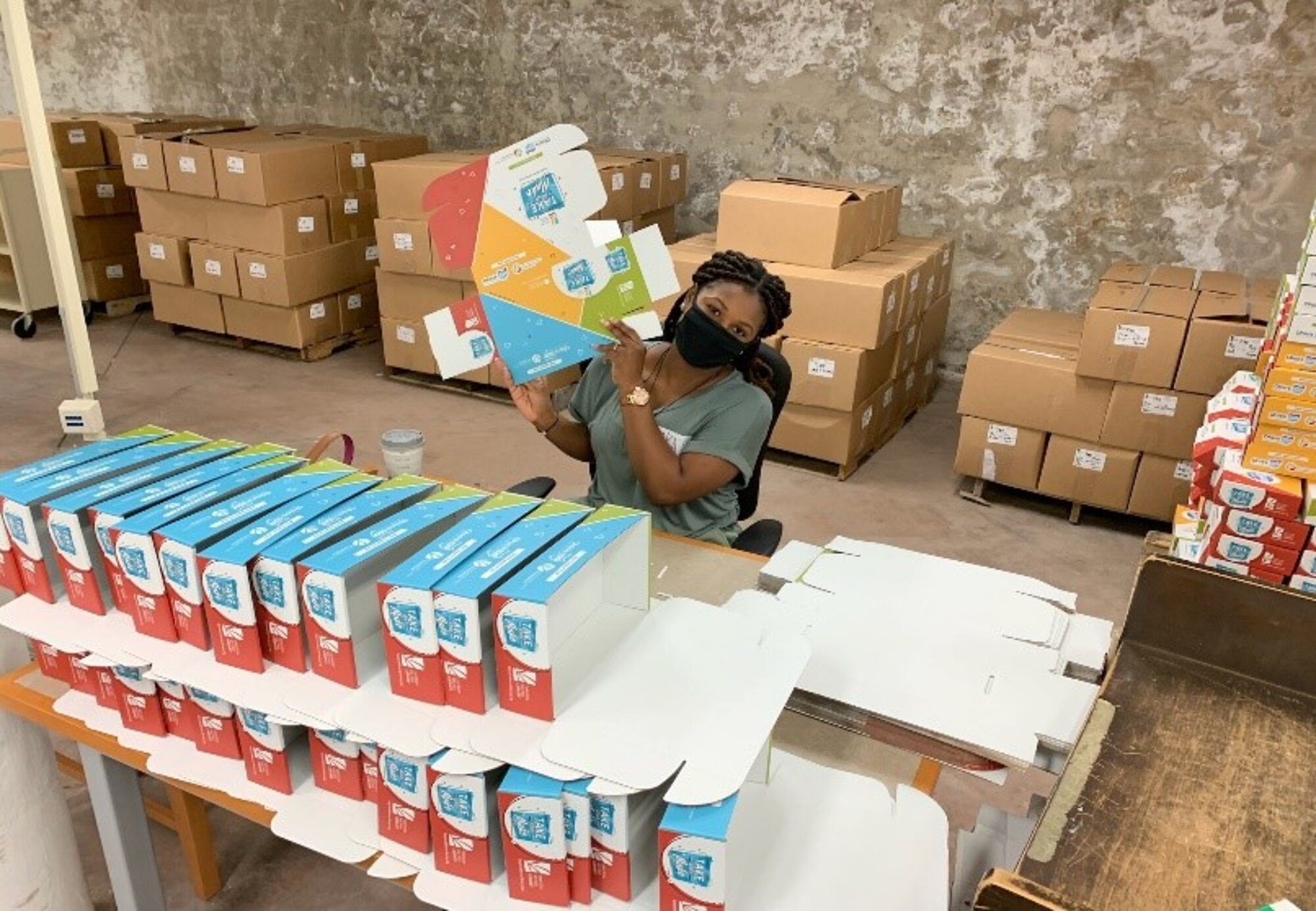 Airman 1st Class Vedrine Katchee puts together a box for the “Take and Make” kits. The volunteer team dedicated 156 total hours to the two-day project at Dayton Metro Library.