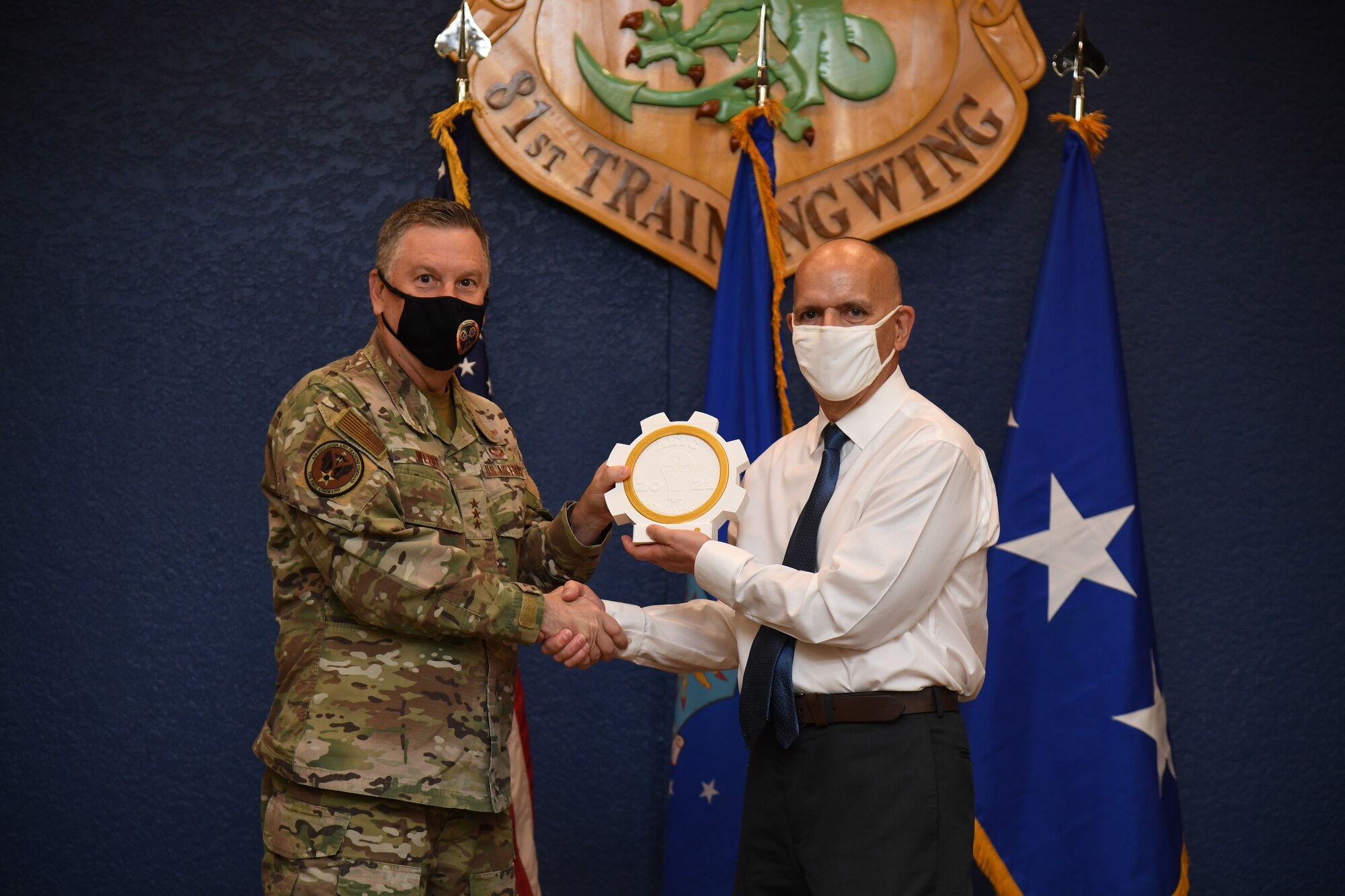 U.S. Air Force Lt. Gen. Marshall B. Webb, commander of Air Education Training Command, presents the iChallenge first place Torch Award to Matthew Correia, Profession of Arms Center of Excellence instructional systems specialist, during the iExpo award ceremony inside the Bay Breeze Event Center at Keesler Air Force Base, Mississippi, May 6, 2021. The iChallenge was created to help inspire personnel around AETC to create new and innovative ways of completing the Air Force mission. Air Force Chief of Staff Gen. Charles Q. Brown, Jr., put in place the Accelerate Change or Lose strategic approach in August 2020 to recognize the rapidly changing technology in the world and to encourage positive change in the Air and Space Forces. This action order has helped shape ideas presented during this year's iChallenge. (U.S. Air Force photo by Kemberly Groue)