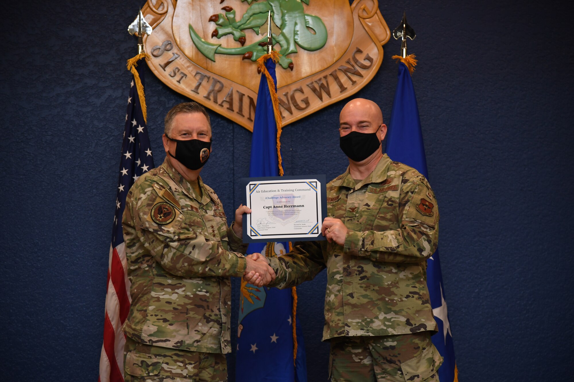 U.S. Air Force Lt. Gen. Marshall B. Webb, commander of Air Education Training Command, presents the iChallenge third place Accelerate Change Award to Col. Paul Swenson, AETC director of manpower, personnel and services, during the iExpo award ceremony inside the Bay Breeze Event Center at Keesler Air Force Base, Mississippi, May 6, 2021. The iChallenge was created to help inspire personnel around AETC to create new and innovative ways of completing the Air Force mission. Air Force Chief of Staff Gen. Charles Q. Brown, Jr., put in place the Accelerate Change or Lose strategic approach in August 2020 to recognize the rapidly changing technology in the world and to encourage positive change in the Air and Space Forces. This action order has helped shape ideas presented during this year's iChallenge. (U.S. Air Force photo by Kemberly Groue)