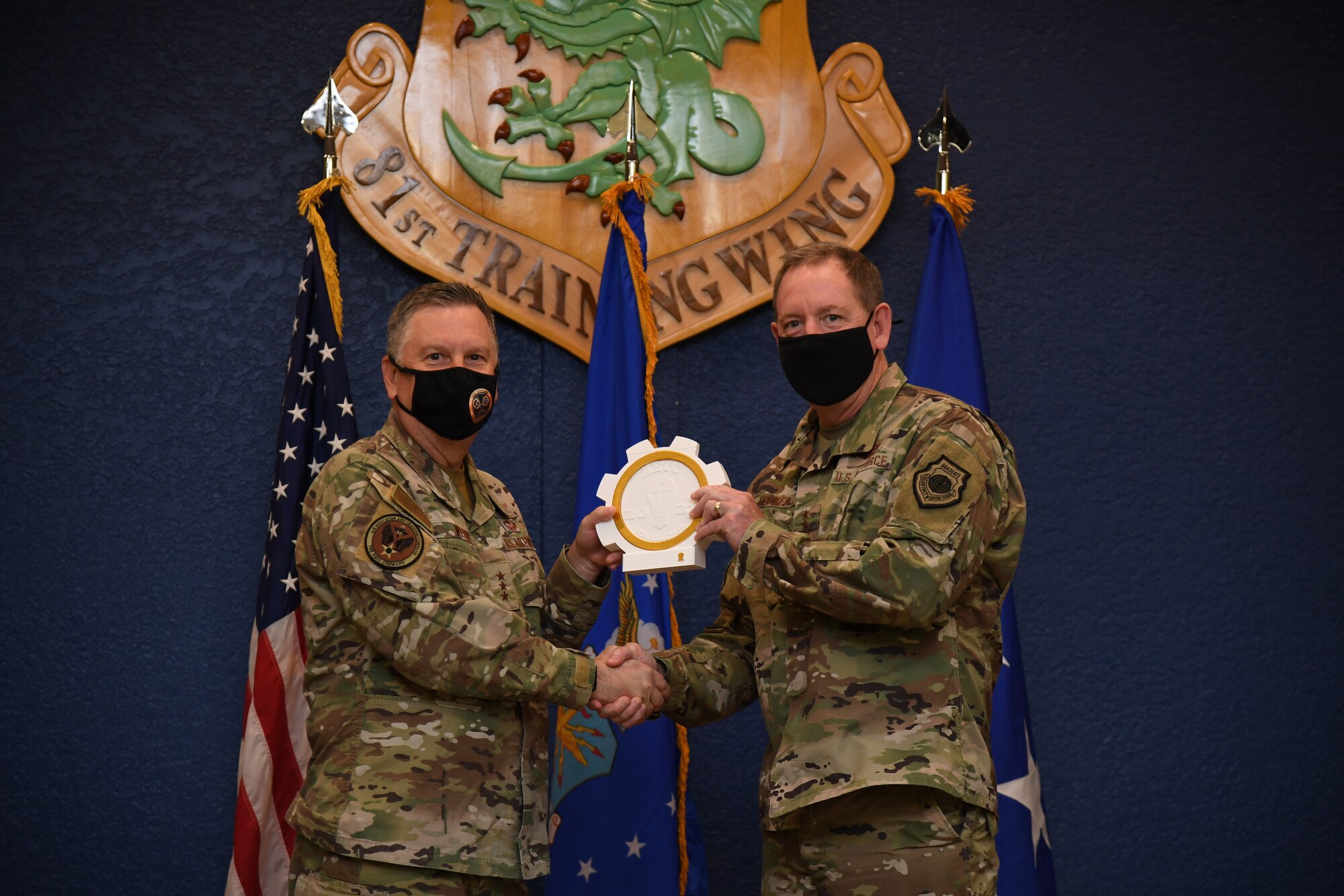 U.S. Air Force Lt. Gen. Marshall B. Webb, commander of Air Education Training Command, presents the iChallenge first place Accelerate Change Award to Lt. Gen. James Hecker, Air University commander and president, during the iExpo award ceremony inside the Bay Breeze Event Center at Keesler Air Force Base, Mississippi, May 6, 2021. The iChallenge was created to help inspire personnel around AETC to create new and innovative ways of completing the Air Force mission. Air Force Chief of Staff Gen. Charles Q. Brown, Jr., put in place the Accelerate Change or Lose strategic approach in August 2020 to recognize the rapidly changing technology in the world and to encourage positive change in the Air and Space Forces. This action order has helped shape ideas presented during this year's iChallenge. (U.S. Air Force photo by Kemberly Groue)