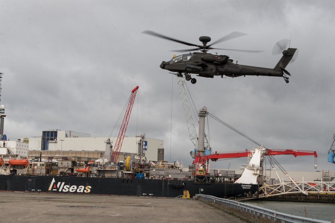 A helicopter flies over a port.