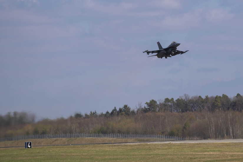 Jet flies over runway