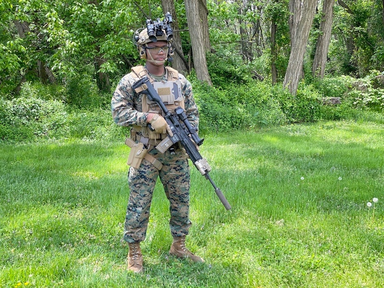 Lance Cpl. Jamichael Chambliss, assigned to Marine Corps’ Training and Education Command, showcases the M27 Infantry Automatic Rifle, Modular Handgun System, High-cut Enhanced Combat Helmet, Squad Binocular Night Vision Goggle, Plate Carrier Generation III with a fold-down holster for the MAGTF Common Handheld, April 29, 2021, aboard Marine Corps Base Quantico, Virginia. Throughout the 2010s, Marine Corps Systems Command developed and fielded several new infantry weapon and optic capabilities designed to increase close-combat lethality and survivability. (U.S. Marine Corps photo by Ashley Calingo)