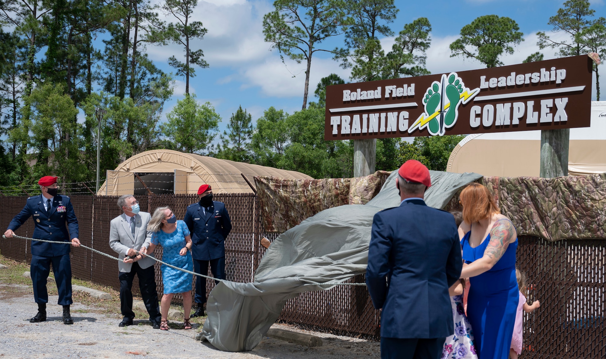 The family of U.S. Air Force Capt. Matthew Roland unveils a sign during a building dedication ceremony at Hurlburt Field, Florida, May 6, 2021. The Special Tactics Training Squadron facility was renamed in honor of Roland, a 23rd STS special tactics officer who died protecting his teammates during an ambush at an Afghan-led security checkpoint near Camp Antonik, Afghanistan, Aug. 26, 2015.
