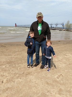 Man and a child boy and girl on a beach