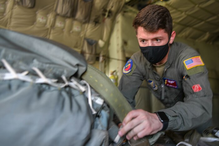 A joint airdrop inspector loadmaster inspects cargo aboard a C130-J super hercules