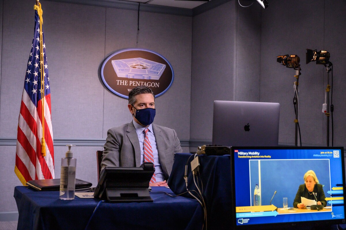 A man speaks at a virtual meeting.