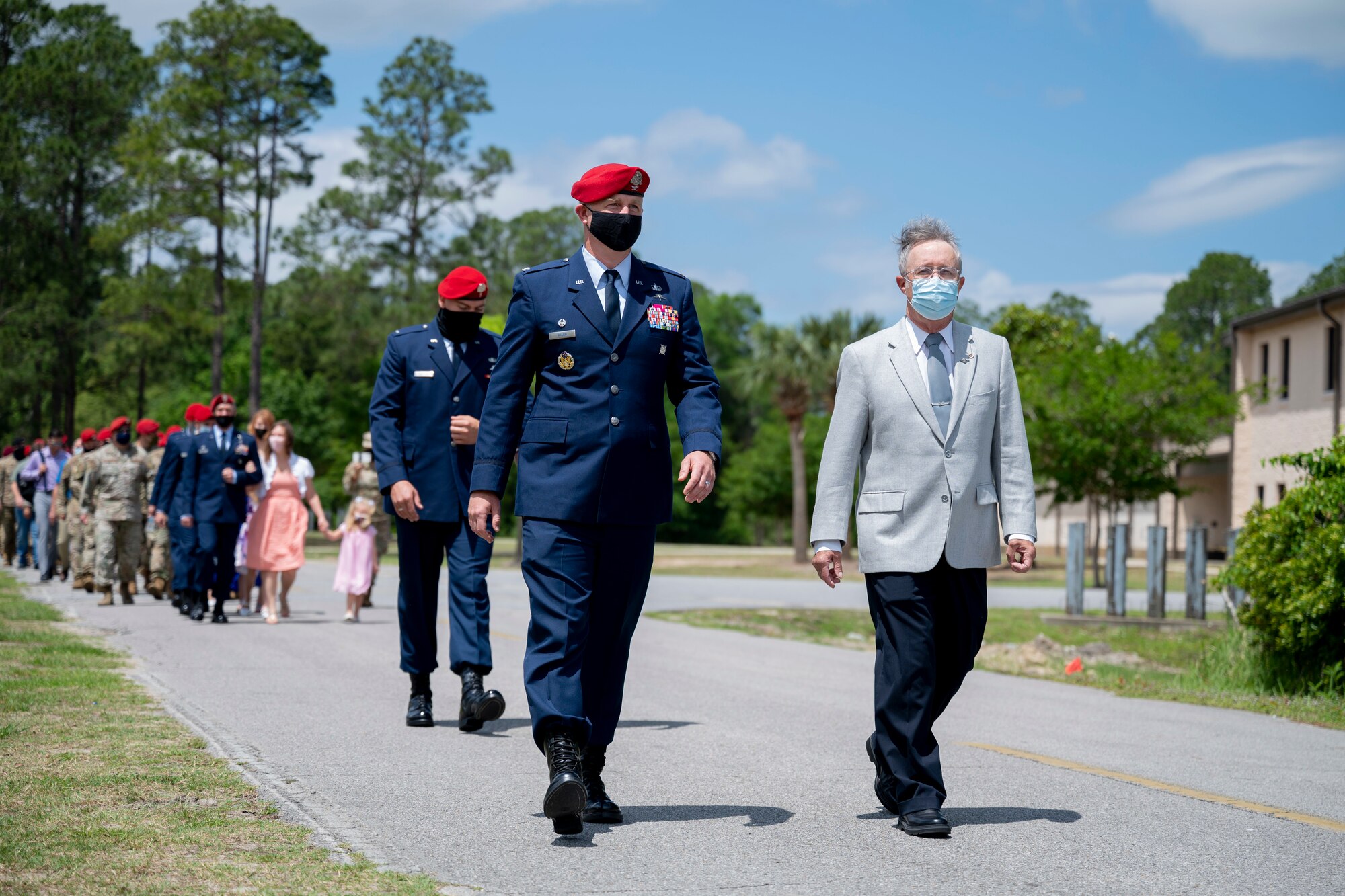 U.S. Air Force Col. Matthew Allen, the commander of the 24th Special Operations Wing, and U.S. Air Force, retired, Col. Mark Roland, father of U.S. Air Force Capt. Matthew Roland, walk to unveil a sign during a building dedication ceremony at Hurlburt Field, Florida, May 6, 2021.