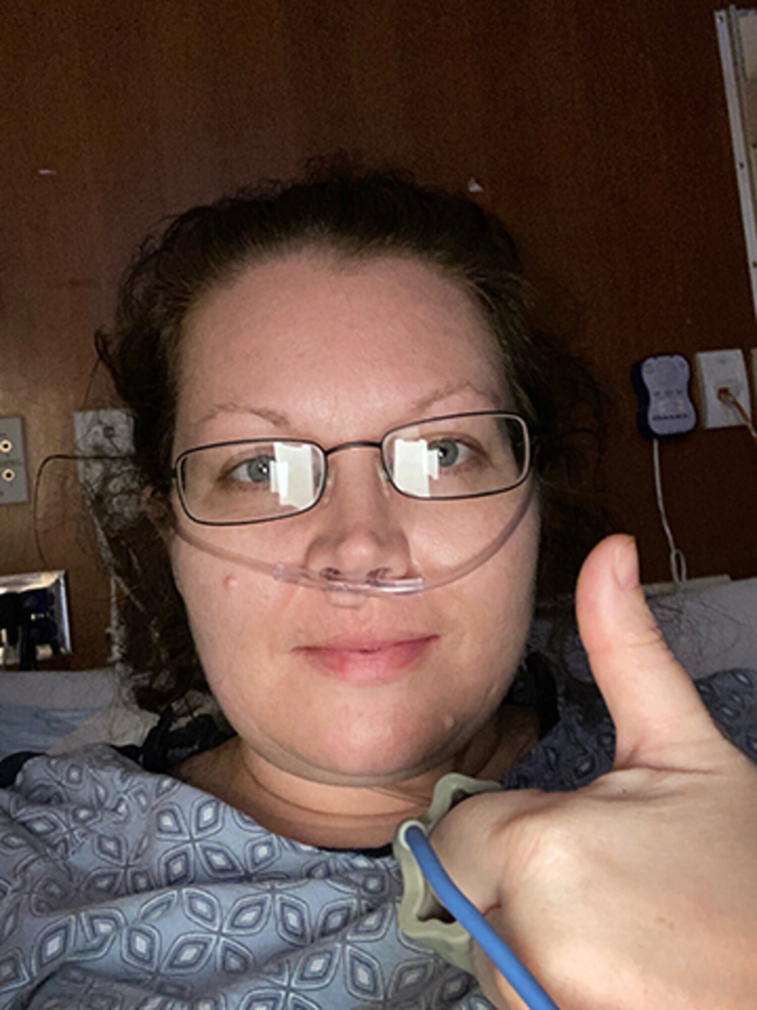 Capt. Danielle Sease, a Global Network Systems Branch budget analyst at Hanscom Air Force Base, Mass., gives a thumbs up while hospitalized with COVID-19, March 31. Sease was diagnosed with the novel Coronavirus and double pneumonia after battling symptoms for nearly a week and is now recovering. (Courtesy photo)