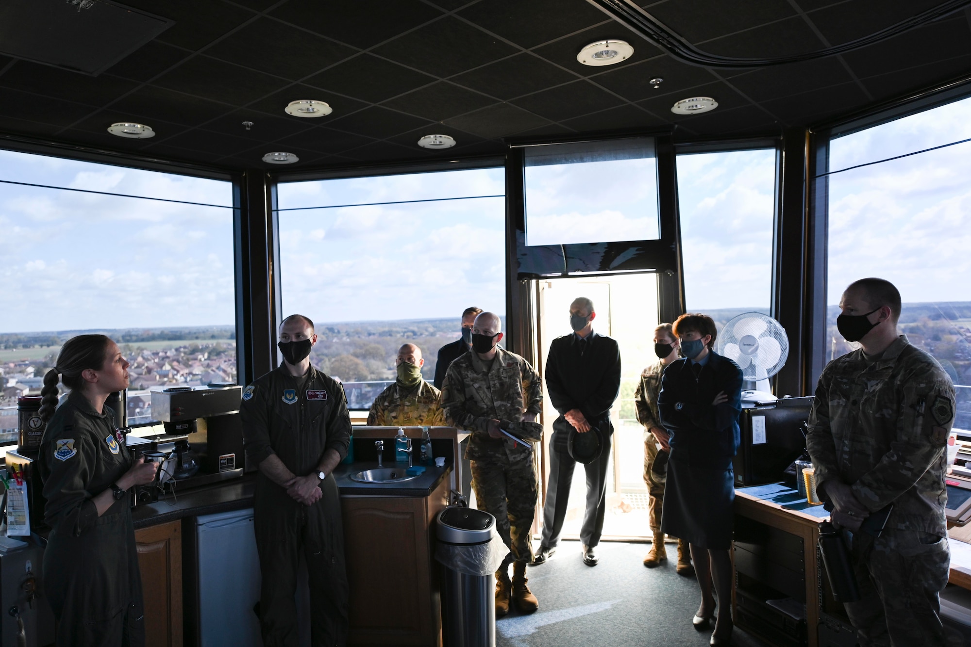 U.S. Airmen assigned to the 100th Air Refueling Wing speak about the strategic importance of the KC-135 Stratotanker aircraft with Gp Capt Joanne Campbell, Royal Air Force Cranwell station commander, inside the air traffic control tower at RAF Mildenhall, England, May 5, 2021. Campbell visited the base to learn about the missions and capabilities of the installation's two wings. (U.S. Air Force photo by Senior Airman Joseph Barron)