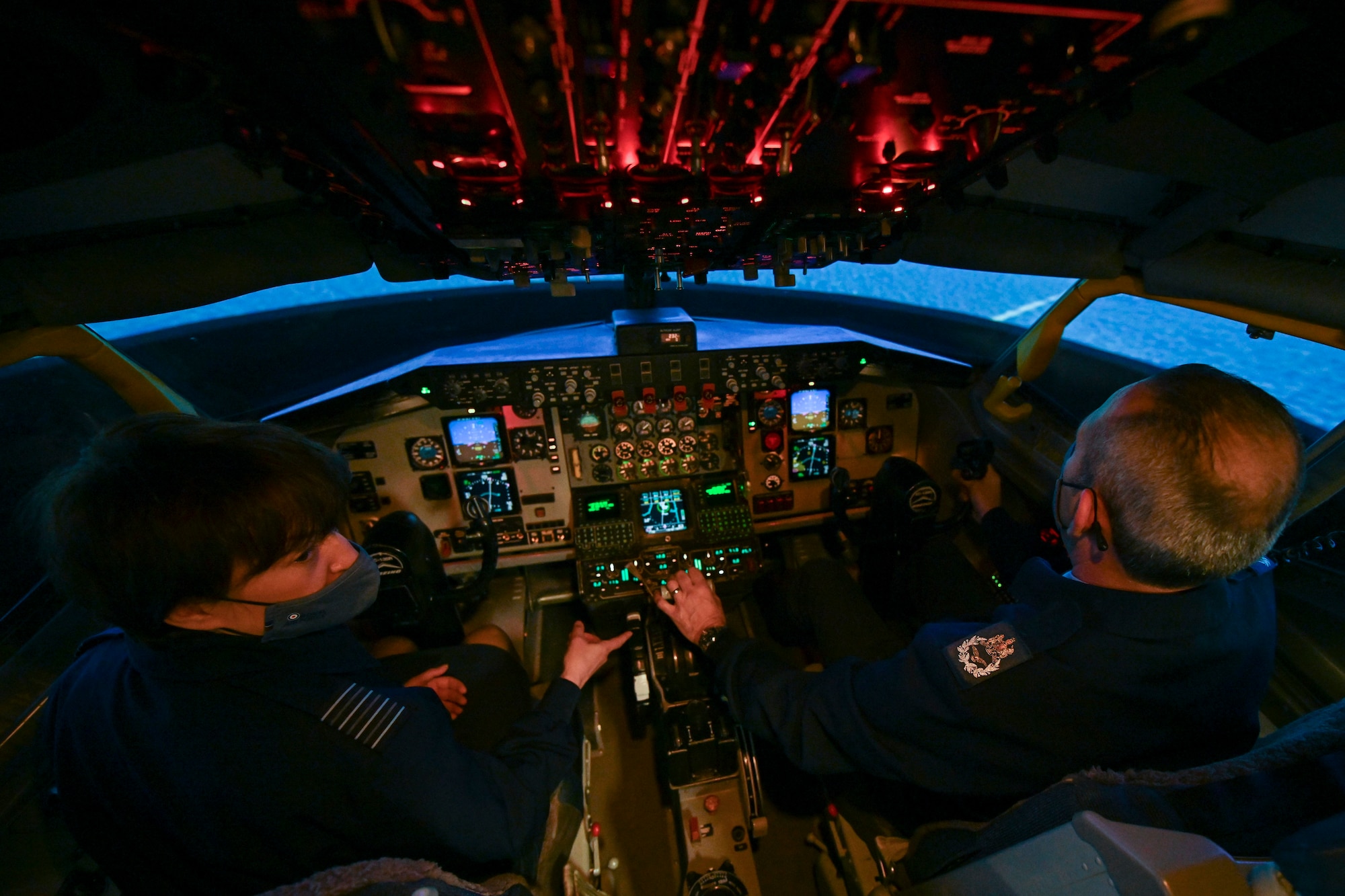 Group Captain Joanne Campbell, Royal Air Force Cranwell station commander, left, and MAcr Marcus Burton, weapons systems operator senior instructor, fly a KC-135 Stratotanker aircraft simulator at RAF Mildenhall, England, May 5, 2021. Campbell and Burton visited the base to learn about U.S. Air Forces in Europe and Air Forces Africa's only permanent air refueling wing. (U.S. Air Force photo by Senior Airman Joseph Barron)