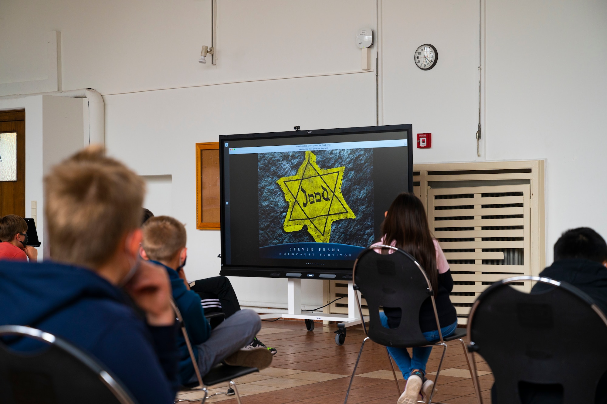 Department of Defense Education Activity students look at an image of a yellow Star of David during a Holocaust remembrance event at Ramstein Air Base, Germany