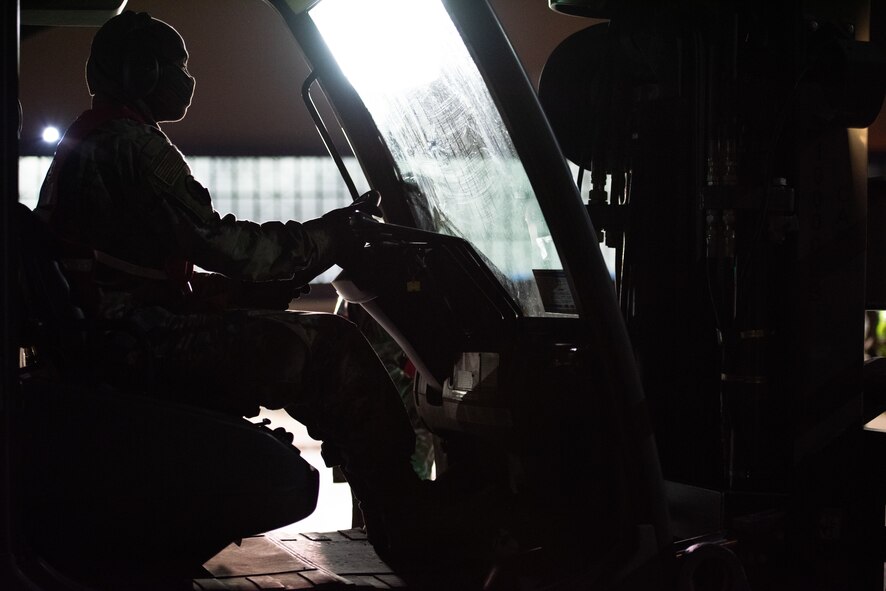 U.S. Air Force Staff Sgt. Andre Thompson, 375th Logistics Readiness Squadron fuels distribution supervisor, drives a forklift with cargo during a mobility exercise on Scott Air Force Base, Illinois, April 28, 2021. Airmen from the 375th LRS worked in teams to process cargo during the exercise to simulate deployment processes. (U.S. Air Force photo by Airman 1st Class Isaac Olivera)