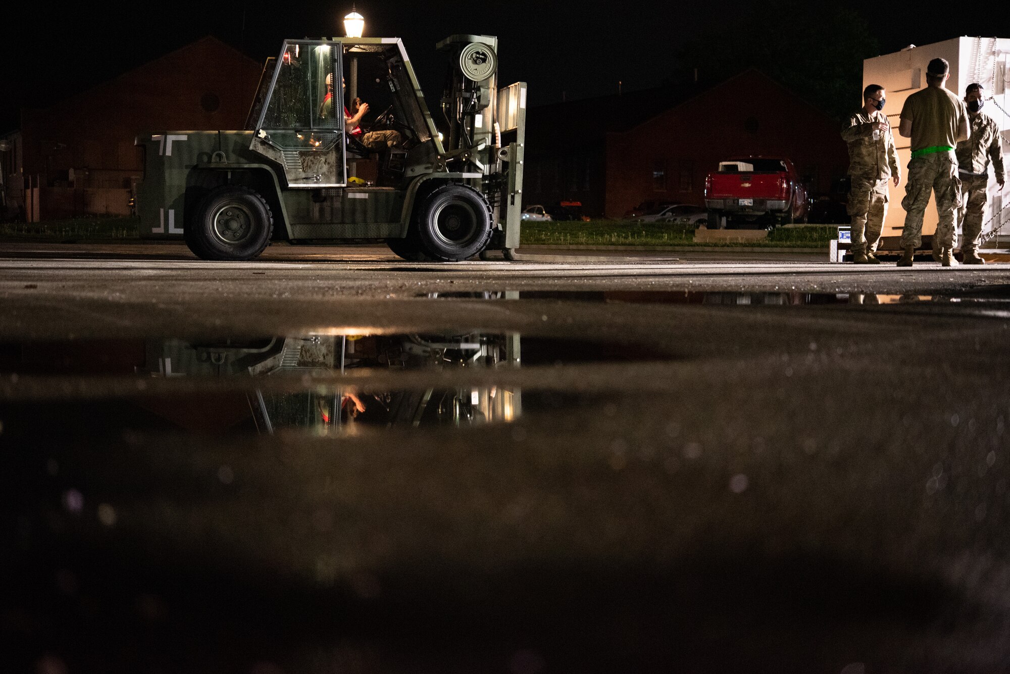 Airmen from the 375th Logistics Readiness Squadron load cargo during a mobility exercise on Scott Air Force Base, Illinois, April 28, 2021. The Air Transportation Flight utilizes their cargo port to process, and move cargo to the aircraft simulating a deployment process. (U.S. Air Force photo by Airman 1st Class Isaac Olivera)