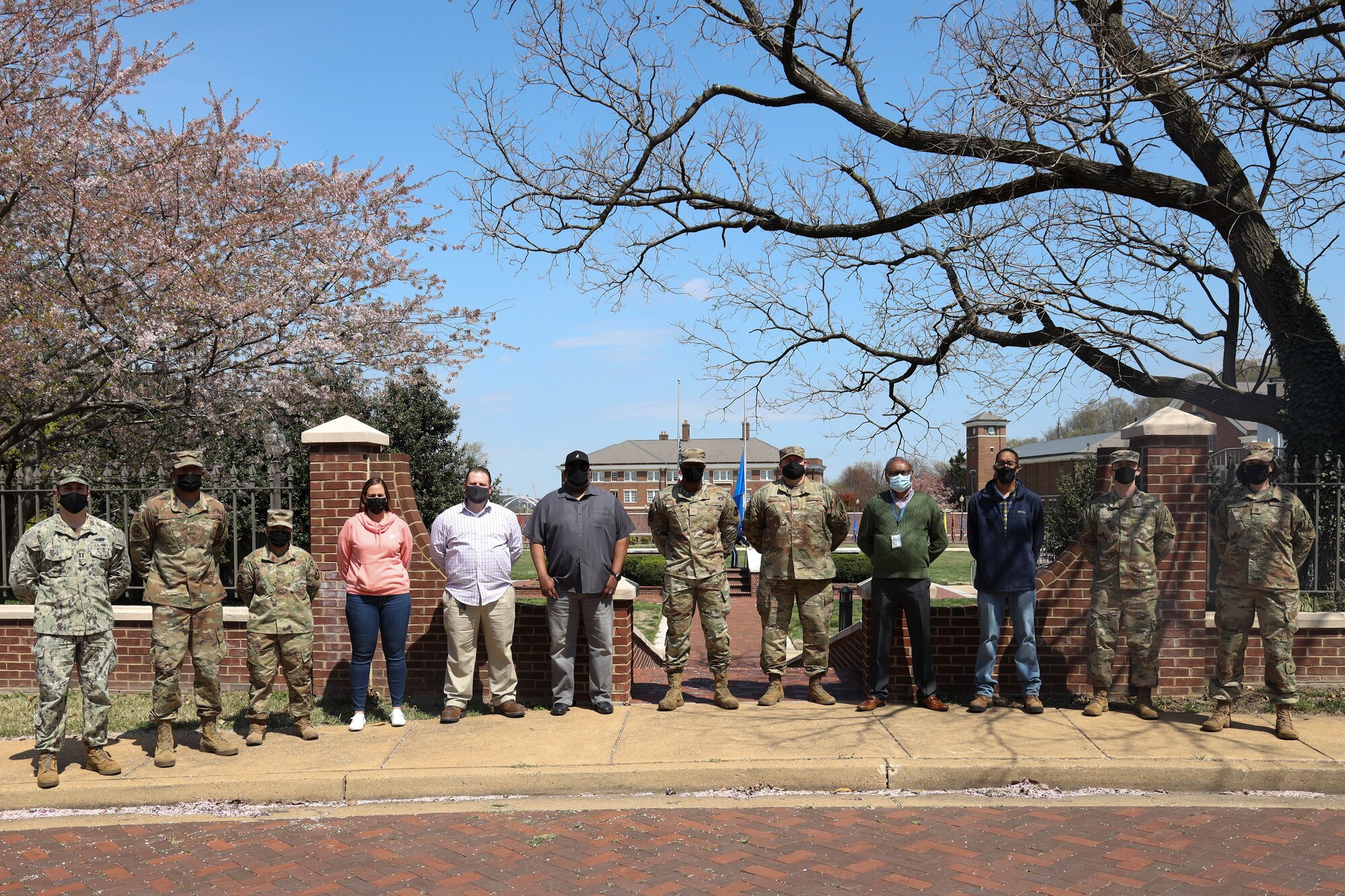 Group photo of R&O Team in front of 11th Wing Building