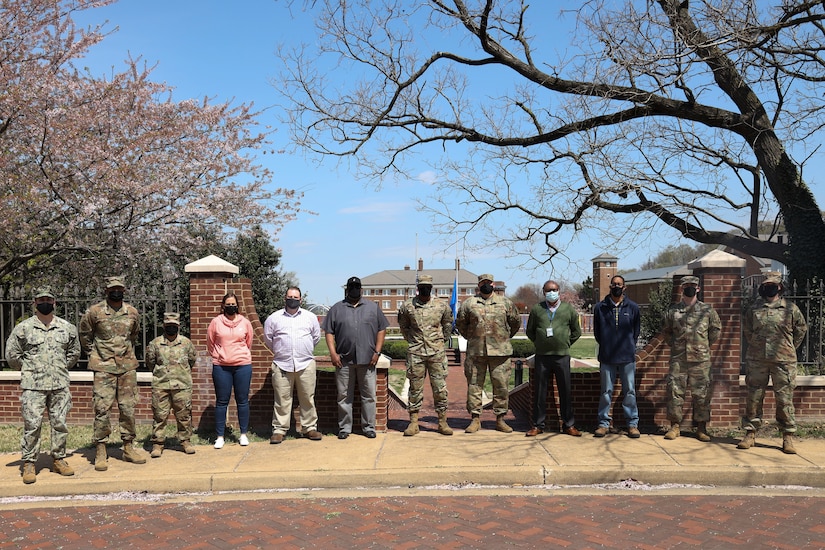 Group photo of R&O Team in front of 11th Wing Building