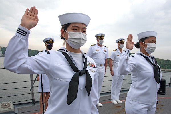 Sailors originally from China and the Philippines recite the Oath of Allegiance aboard USS Mustin (DDG 89) during a United States Citizenship and Immigration Services naturalization ceremony.