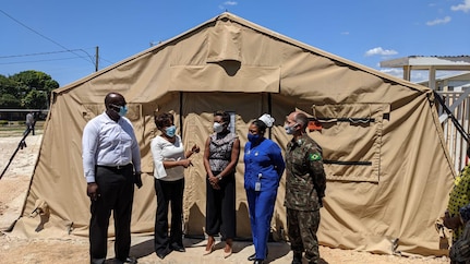 Brig. Gen. Alcides V. Faria, right, U.S. Army South deputy commanding general for interoperability, receives a tour by representatives of the Ministry of Health and Wellness of a U.S.-funded mobile field hospital based at the Spanish Town Hospital in St. Catherine, Jamaica, April 29, 2021.