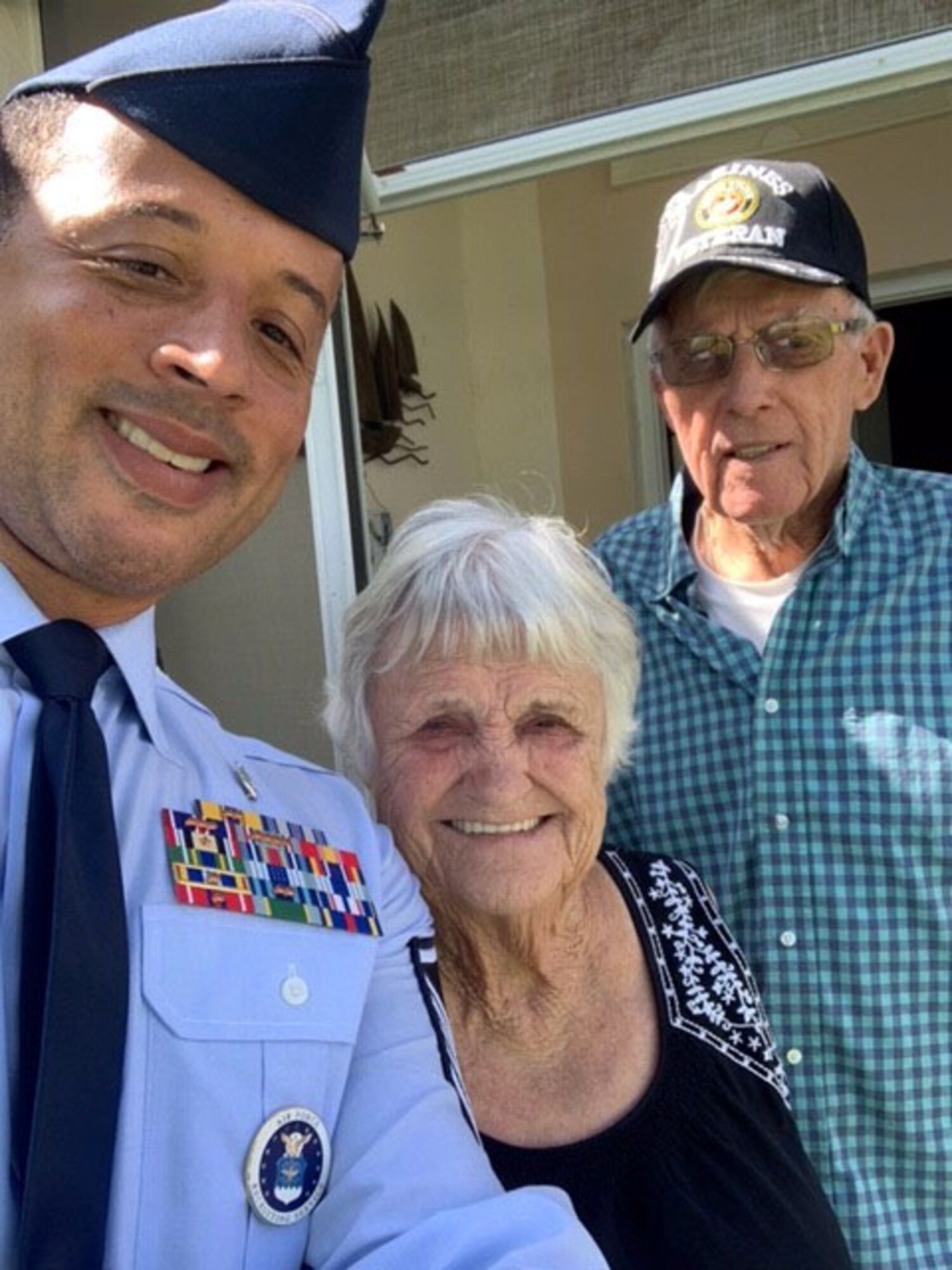 Master Sgt. Carlton Holt, 333rd Recruiting Squadron first sergeant, Patrick Space Force Base, Florida, poses with his neighbors, Francine and Daniel.