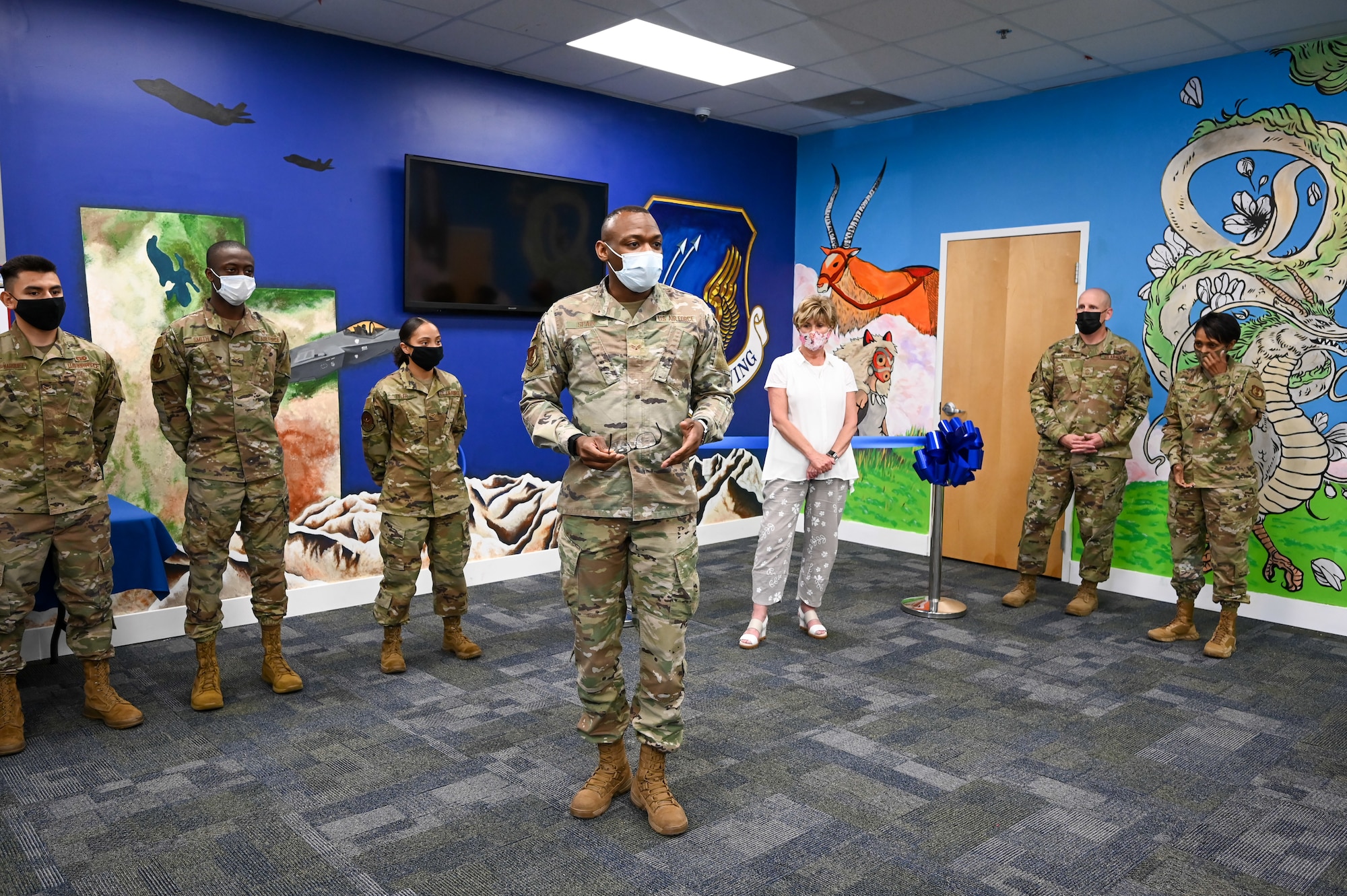 Senior Airman Dennis Spain speaks to guests inside the Airman Recreation Center.