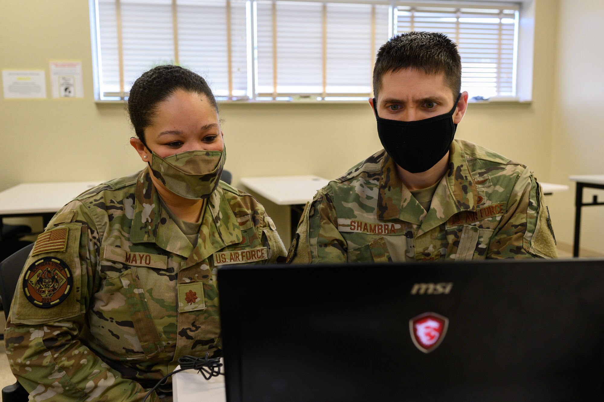 (From left) U.S. Air Force Maj. Christina Mayo, cyber operator for the 175th Cyberspace Operations Squadron, Maryland Air National Guard, and U.S. Air Force Capt. Stephen Shambra, cyber warfare officer for the 275 Cyberspace Operations Squadron, work on a computer April 22, 2021, at the Gulfport Combat Readiness Training Center, Gulfport, Mississippi.