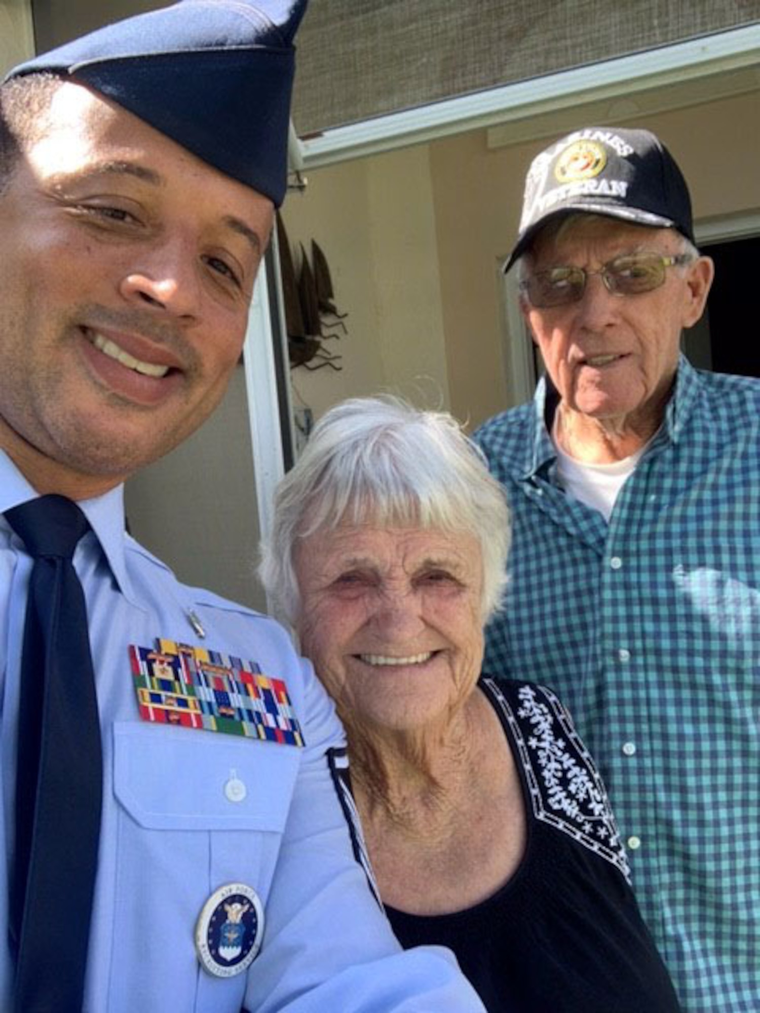 Master Sgt. Carlton Holt, 333rd Recruiting Squadron first sergeant, Patrick Space Force Base, Florida, poses with his neighbors, Francine and Daniel.