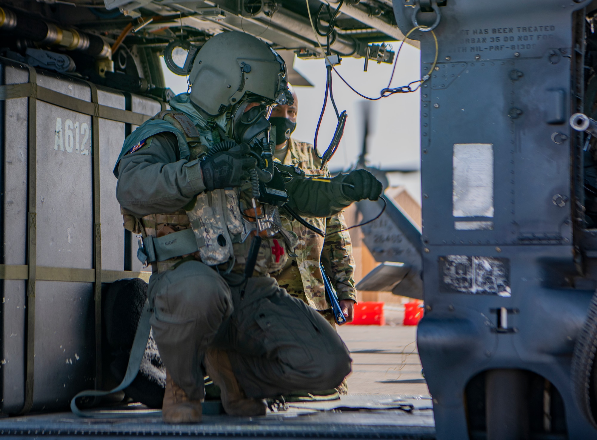 Airman performs pre-flight checks on a helicopter.