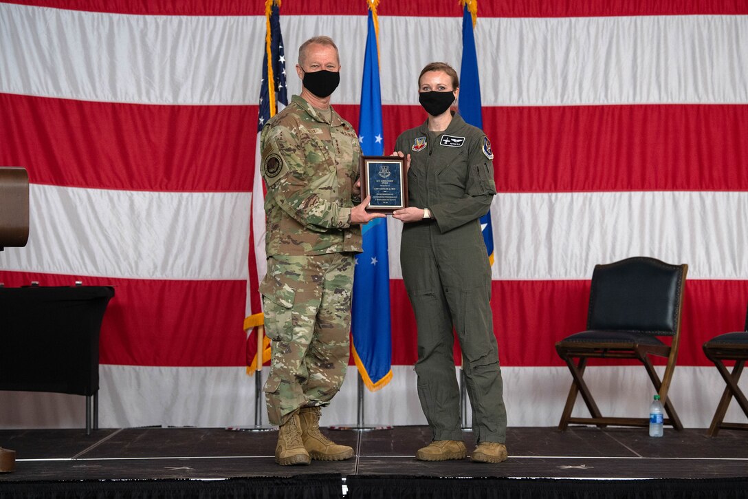 A photo of General Kelly and Captain Bye holding a plaque.
