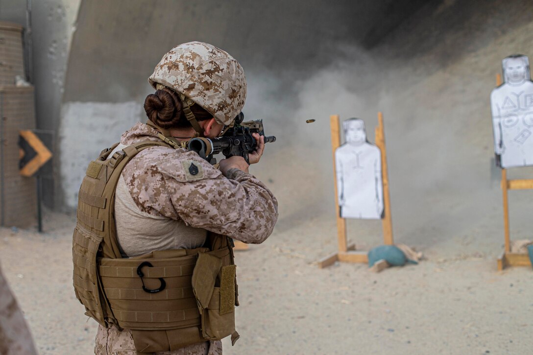 A Marine fires a weapon at a target.