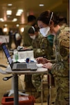 Technicians with the 30th Medical Group process patients receiving their COVID-19 vaccinations during a POD event Jan. 6, 2021, at Vandenberg Air Force Base.