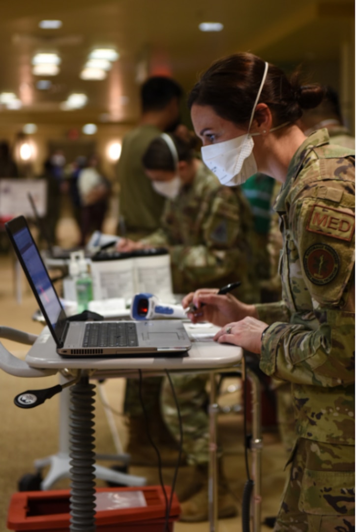 Technicians with the 30th Medical Group process patients receiving their COVID-19 vaccinations during a POD event Jan. 6, 2021, at Vandenberg Air Force Base.